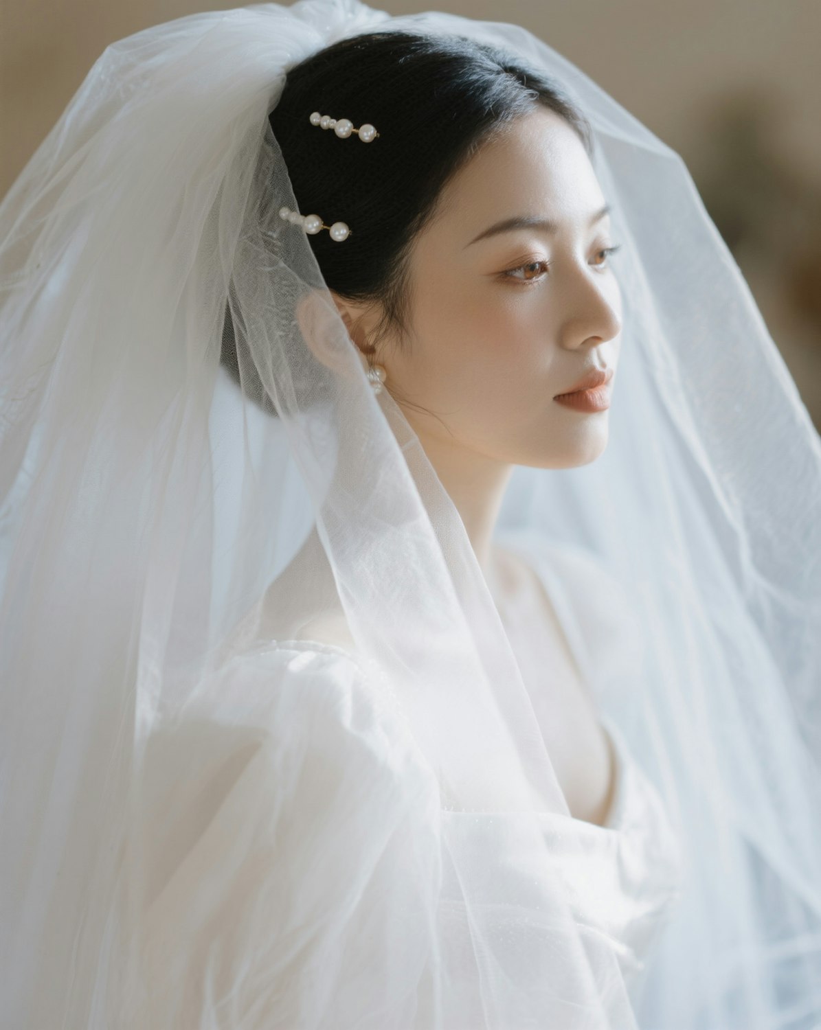 A bride in a veil with pearl hairpins